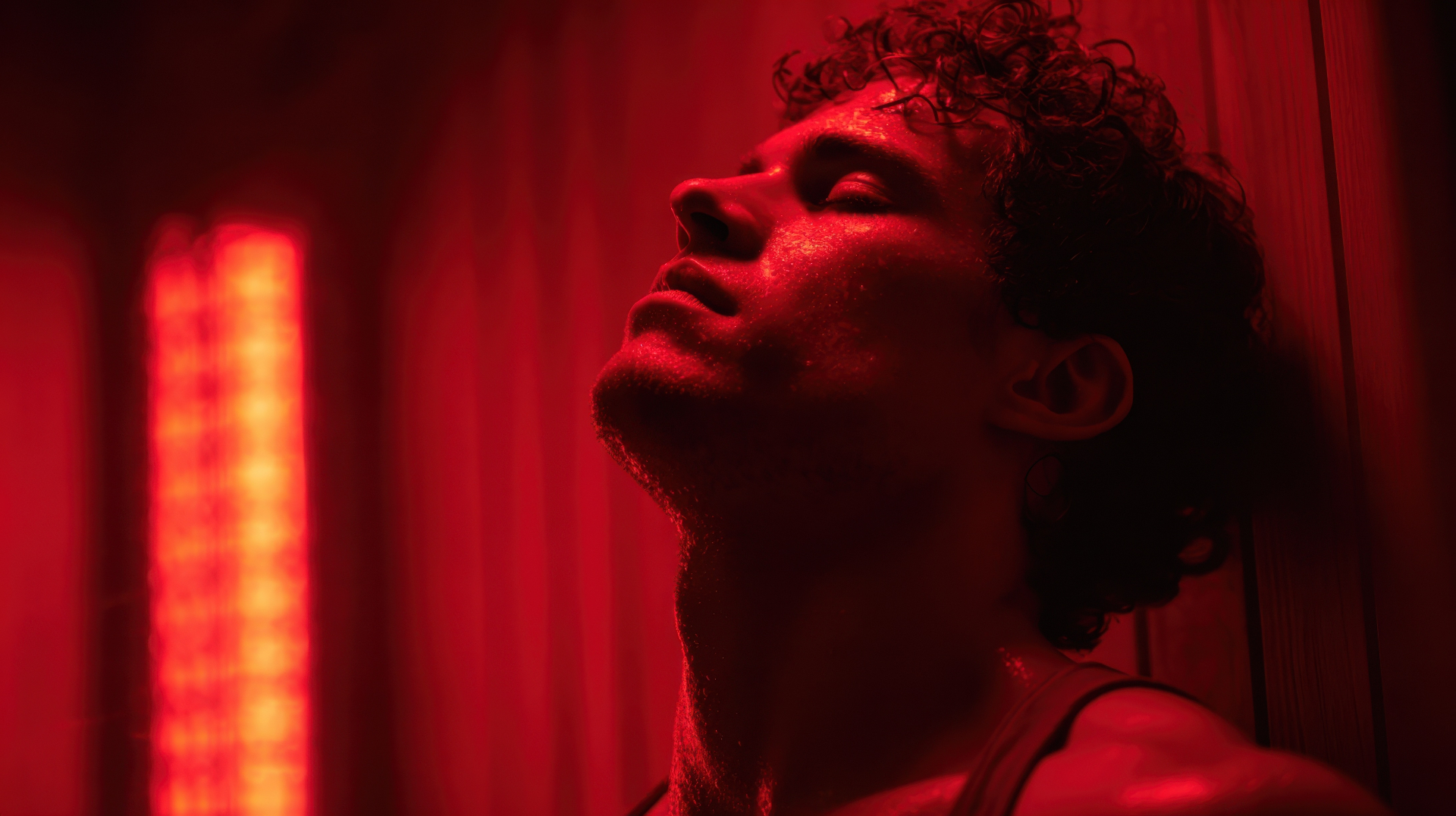 What to expect during an infrared sauna therapy session Man enjoying deep infrared sauna therapy session with red light at REDSOL Wellness Club League City TX
