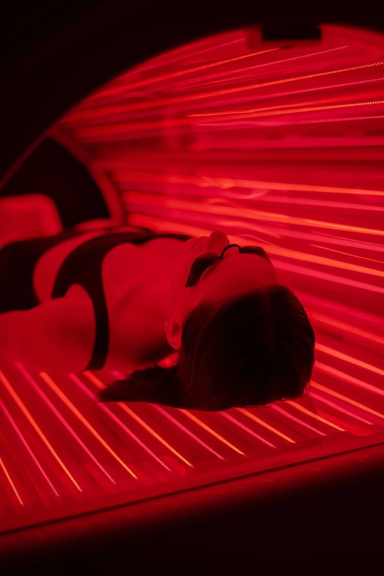 Red light therapy Pro-Bed session with dramatic red LED glow at REDSOL Wellness Club League City TX